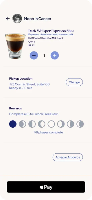 The order screen: a Dark Whisper Espresso Shot described as Espresso, pistachio cream, steamed milk, in Half Moon (12oz) with Oat Milk and Light, quantity 1 at $9.72 with a minus and plus stepper. Below it a Pickup Location of 123 Cosmic Street, Suite 100, ready in about 10 minutes, with a Change button; a Rewards row headed Complete all 8 to unlock Free Brew! with eight moon phases, the first one filled, reading 1/8 phases complete; an Agregar Artículos button; and an Apple Pay button.